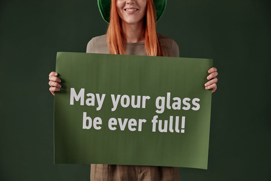 Woman holding St. Patrick's Day poster with cheerful message. Studio shoot.
