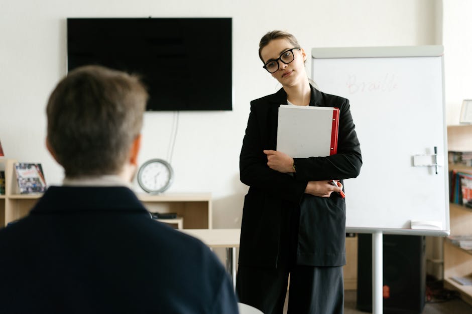 A businesswoman holding documents and presenting in a modern office.