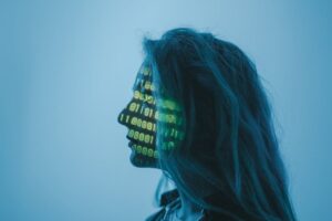 Silhouette of a woman with binary code projected on her face in a digital concept setting.