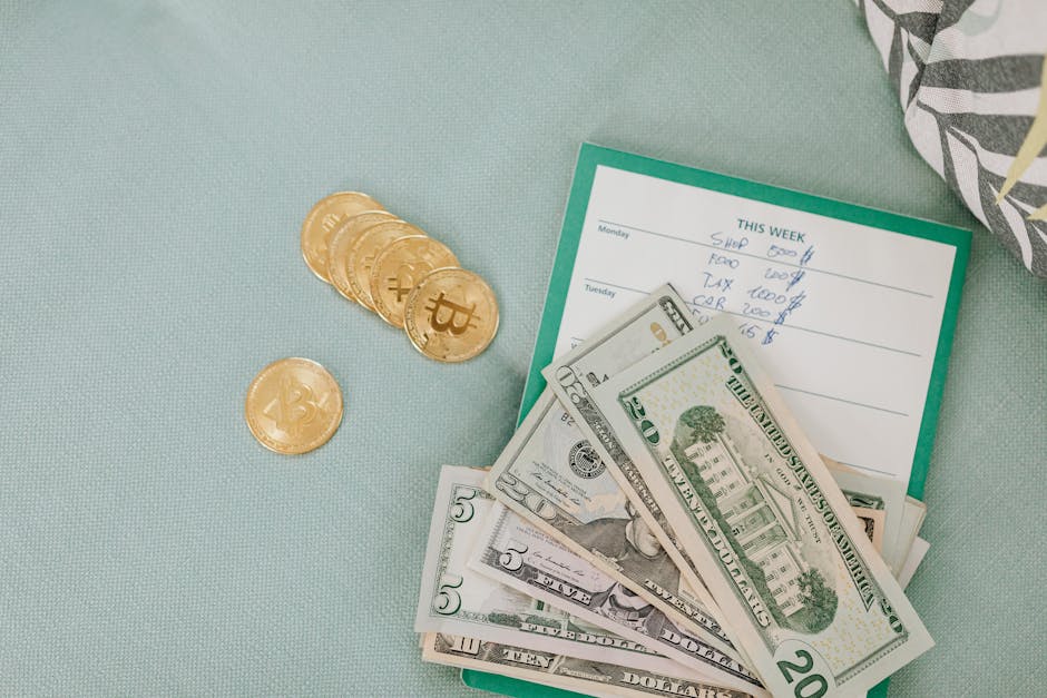 Close-up of U.S. dollars and Bitcoin coins placed on a weekly budget planner, symbolizing modern finance.