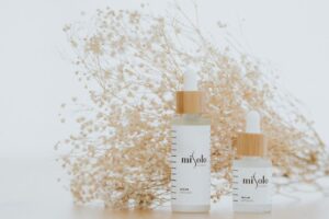 Minimalist serum bottles with natural backdrop, perfect for luxury cosmetics ads.