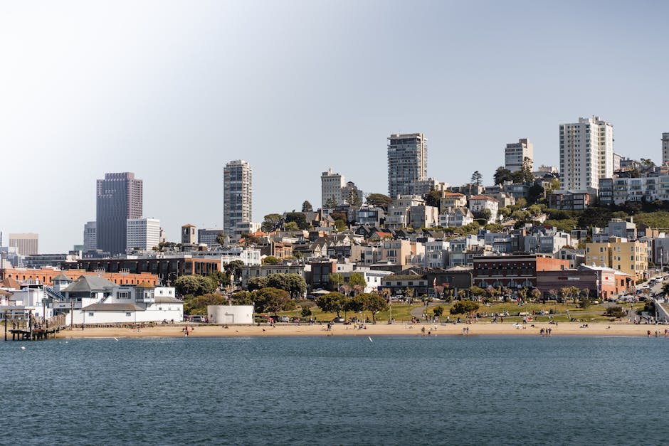 A scenic view of San Francisco's coastal skyline with beachfront and urban landscape.