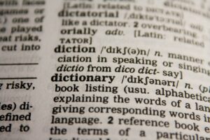Detailed close-up view of a dictionary page highlighting the word 'dictionary' and its definition.
