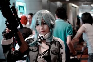 Vibrant cosplay participant posing indoors at a bustling convention scene.